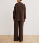 Back view of woman's brown linen co-ord set showing button-down shirt and wide-leg trousers