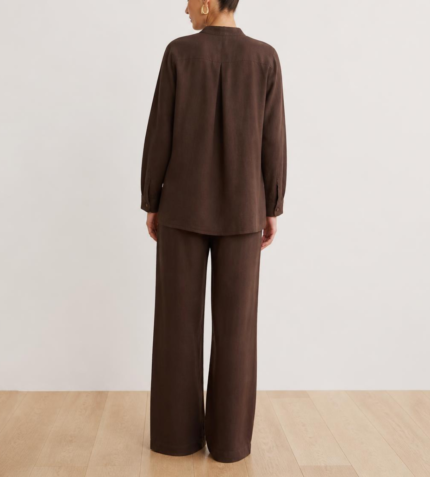 Back view of woman's brown linen co-ord set showing button-down shirt and wide-leg trousers
