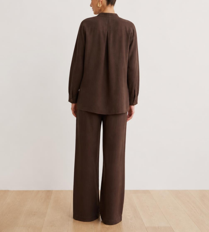 Back view of woman's brown linen co-ord set showing button-down shirt and wide-leg trousers