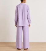 Back view of woman's lavender linen co-ord set showing button-down shirt and wide-leg trousers