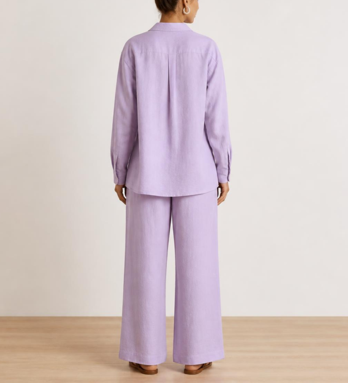 Back view of woman's lavender linen co-ord set showing button-down shirt and wide-leg trousers