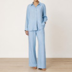 Woman wearing an azure linen co-ord set with button-down shirt and wide-leg trousers, front view