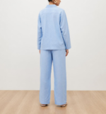 Back view of woman's azure linen co-ord set showing button-down shirt and wide-leg trousers