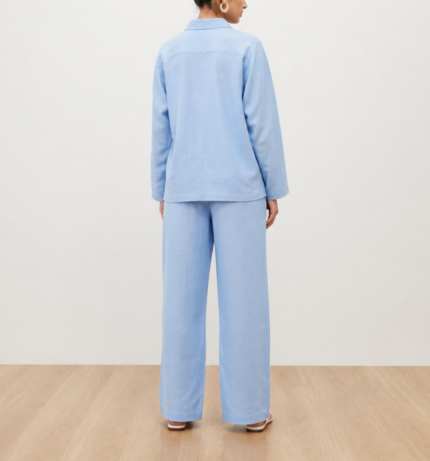 Back view of woman's azure linen co-ord set showing button-down shirt and wide-leg trousers