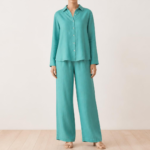 Woman wearing a turquoise linen co-ord set with button-down shirt and wide-leg trousers, front view