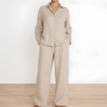 Woman wearing a beige linen co-ord set with button-down shirt and wide-leg trousers