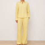 Woman wearing a butter yellow linen co-ord set with button-down shirt and wide-leg trousers, front view