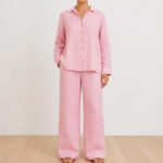Woman wearing a pink linen co-ord set with button-down shirt and wide-leg trousers, front view