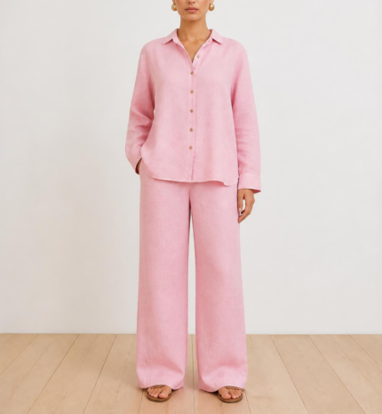 Woman wearing a pink linen co-ord set with button-down shirt and wide-leg trousers, front view