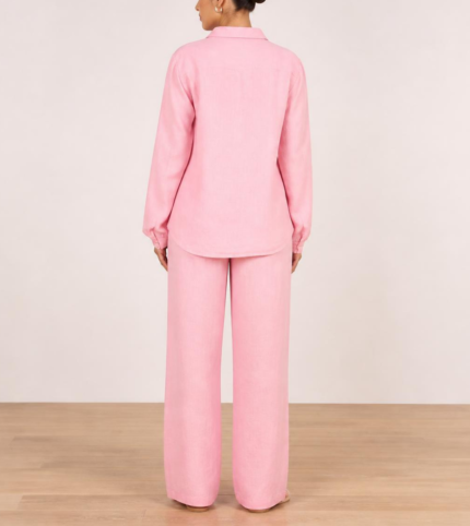 Back view of woman's pink linen co-ord set showing button-down shirt and wide-leg trousers